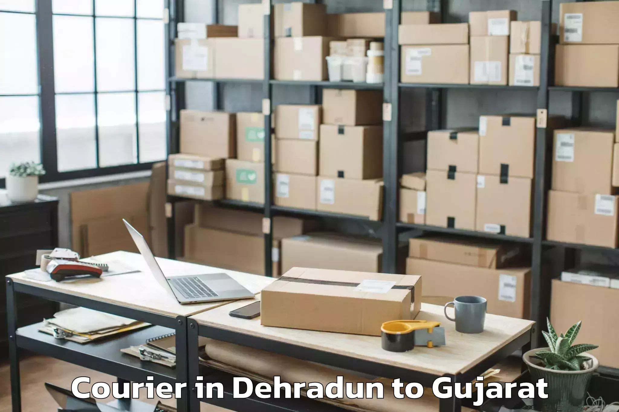 Book Dehradun to Jodiya Bandar Courier Online